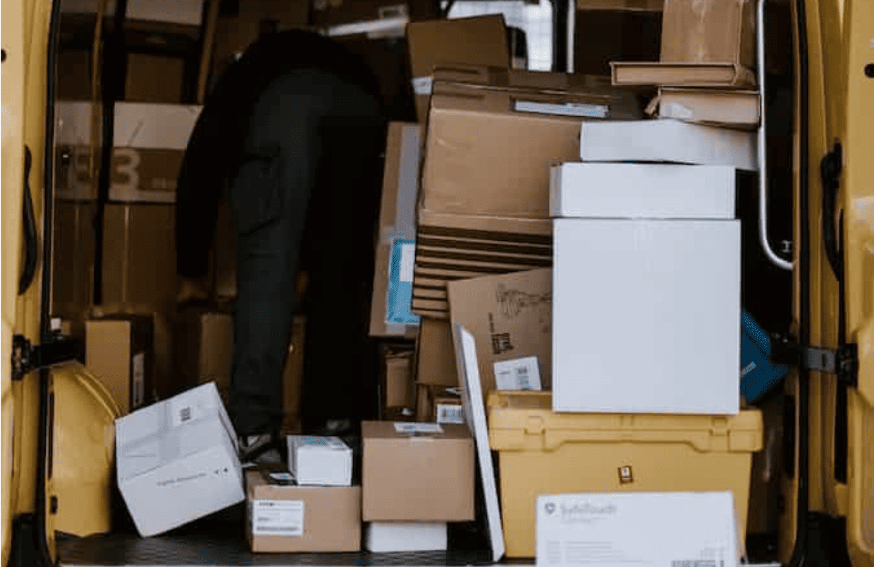 Packages piled in delivery van after peak season shipping delays